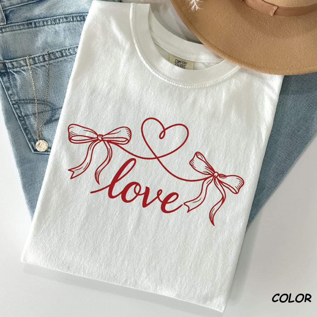 White Comfort Colors t-shirt with a minimalist ribbon heart string illustration for Valentine's Day.