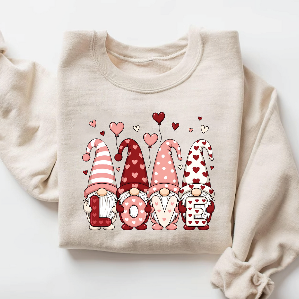 and beige pullover sweatshirt with cute Nordic gnomes in pink and red heart hats spelling out LOVE