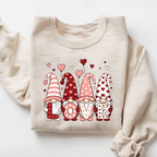 and beige pullover sweatshirt with cute Nordic gnomes in pink and red heart hats spelling out LOVE