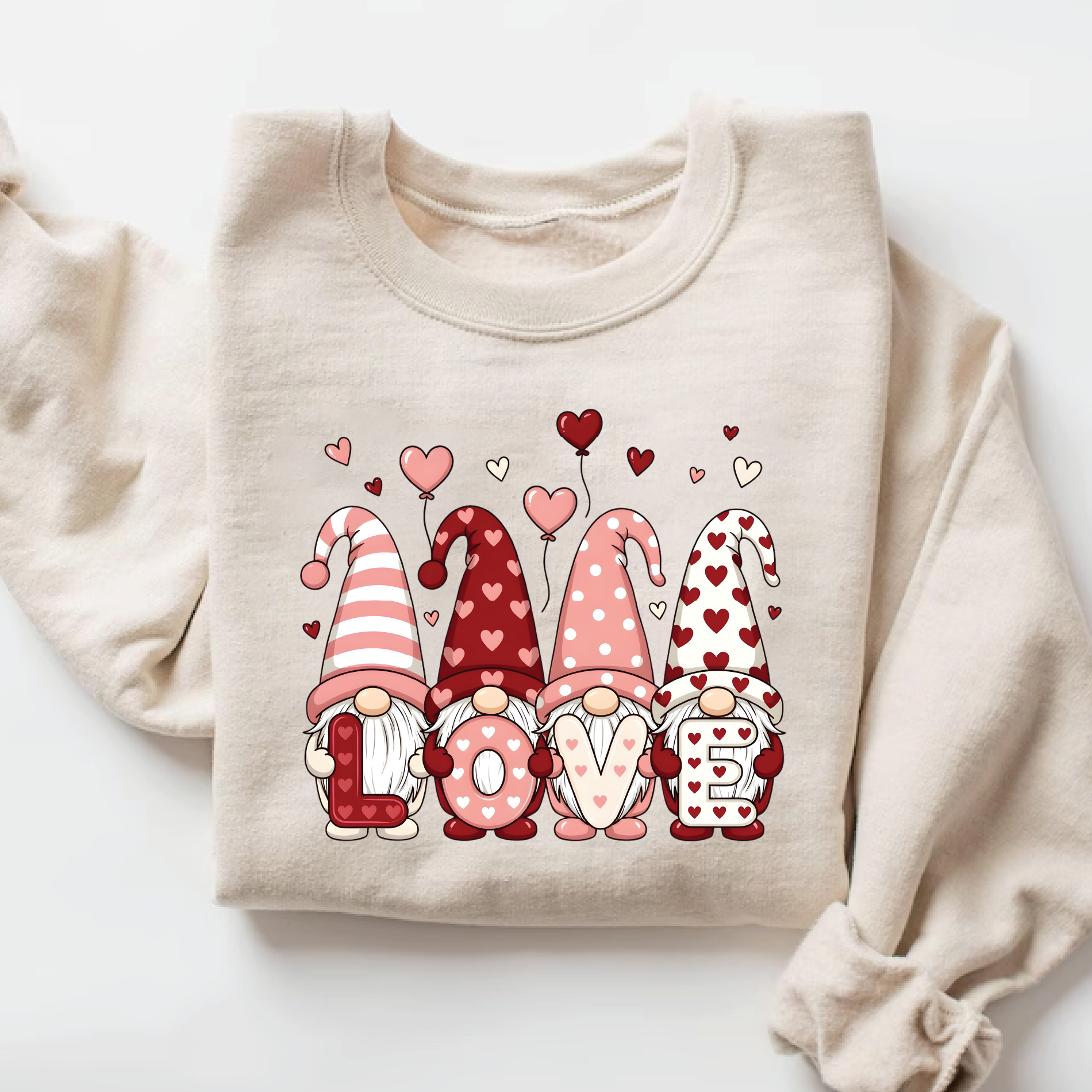 and beige pullover sweatshirt with cute Nordic gnomes in pink and red heart hats spelling out LOVE