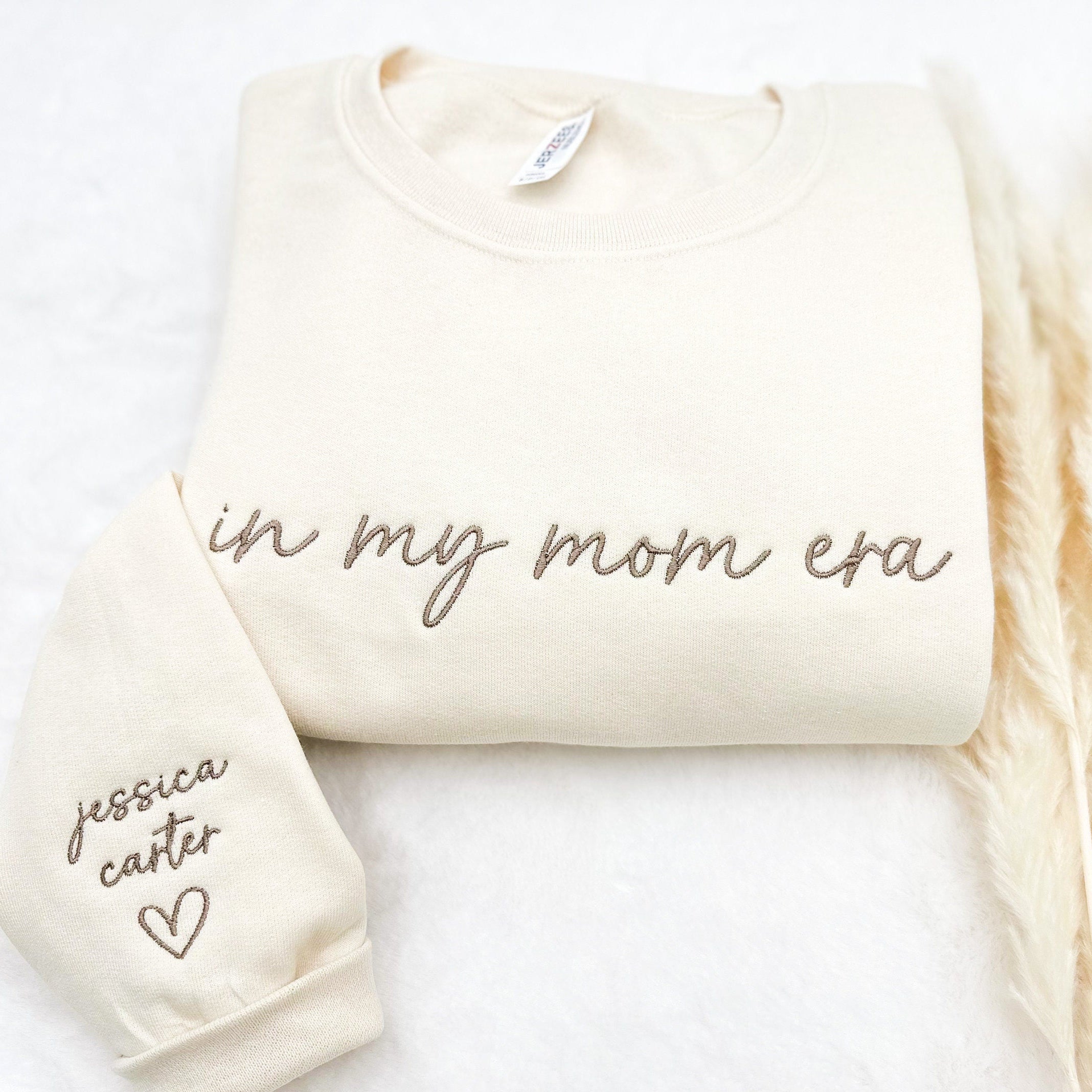 “In My Mom Era embroidered sweatshirt with custom kids’ names on sleeve – neutral cream tone”