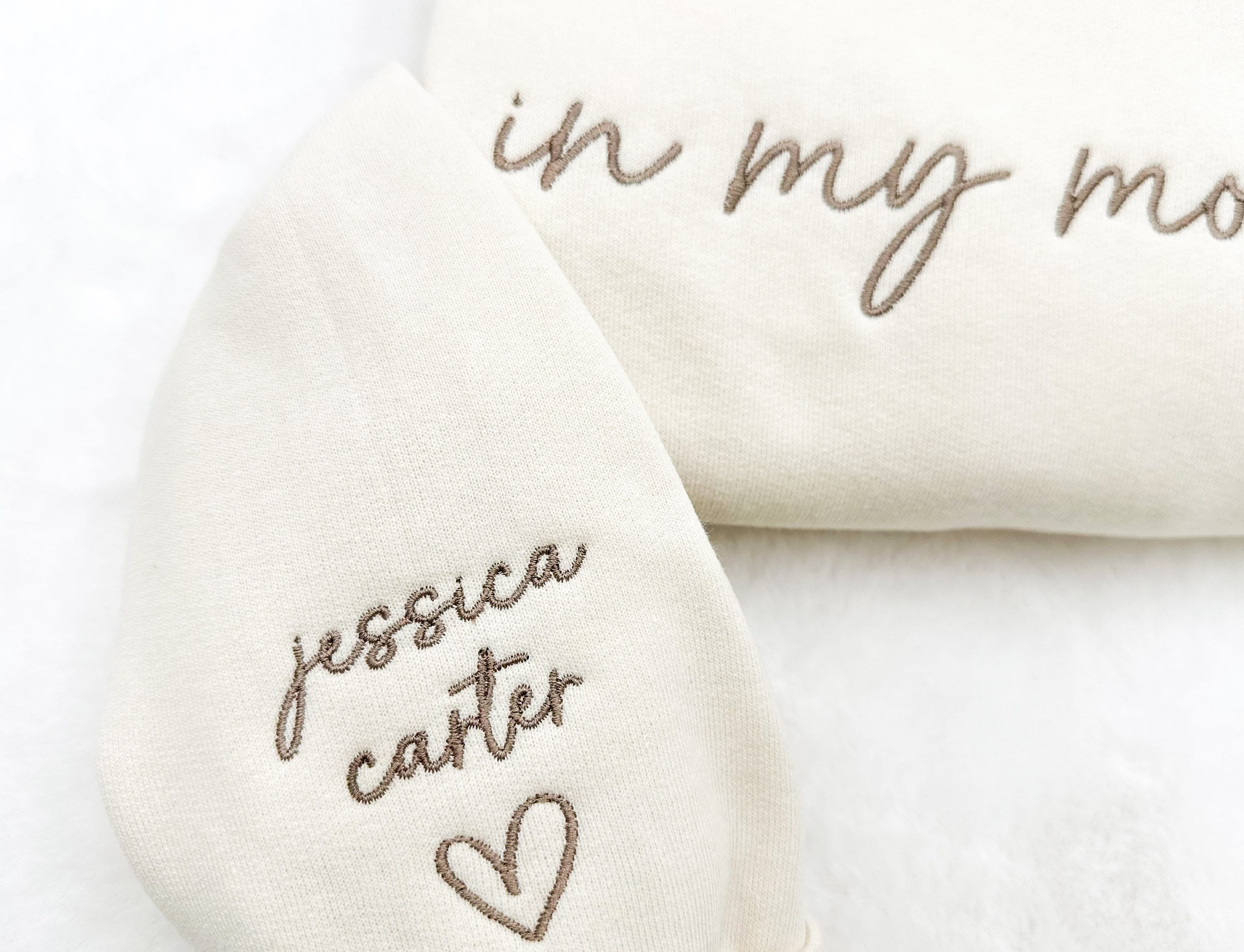“In My Mom Era embroidered sweatshirt with custom kids’ names on sleeve – neutral cream tone”