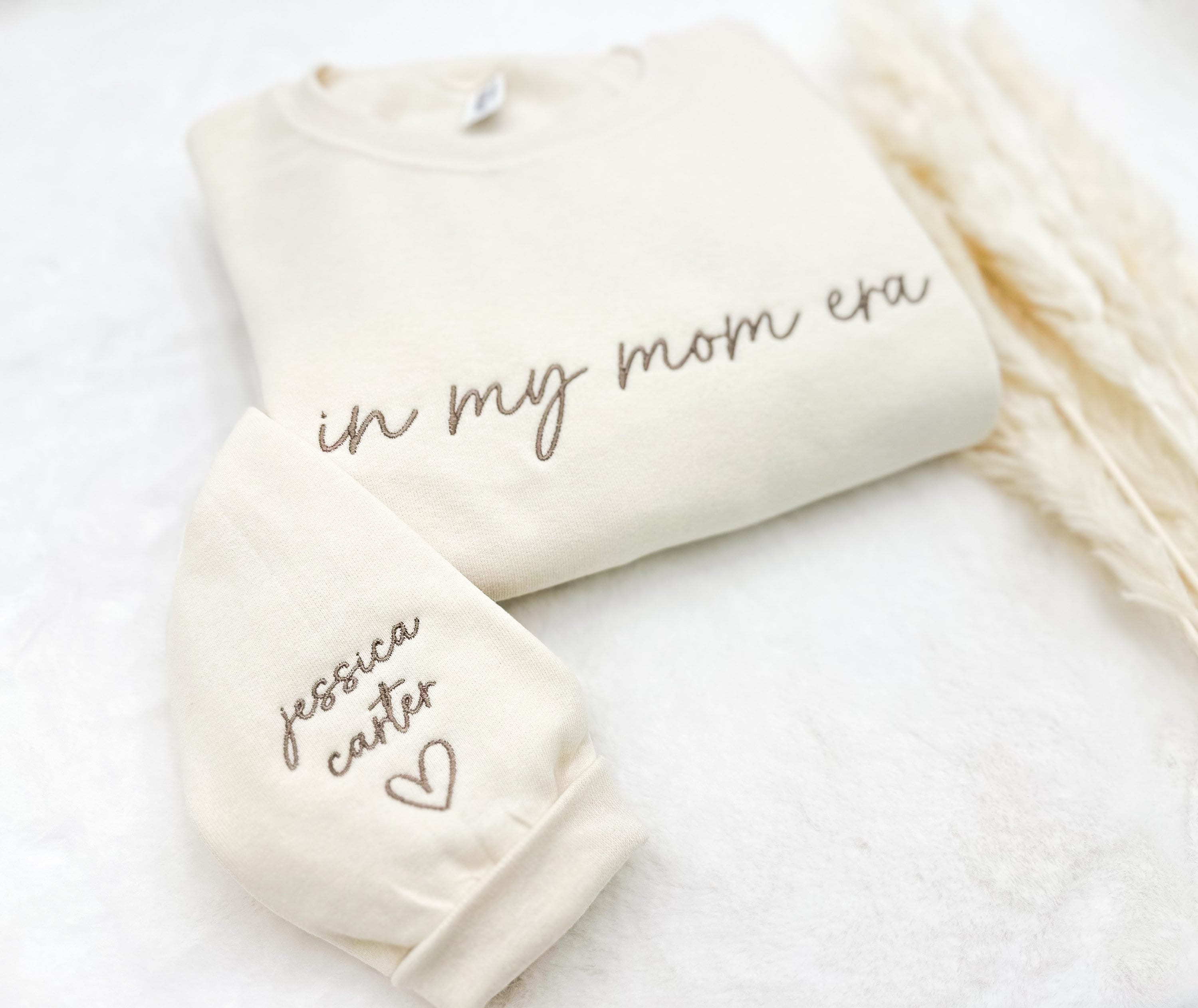 “In My Mom Era embroidered sweatshirt with custom kids’ names on sleeve – neutral cream tone”
