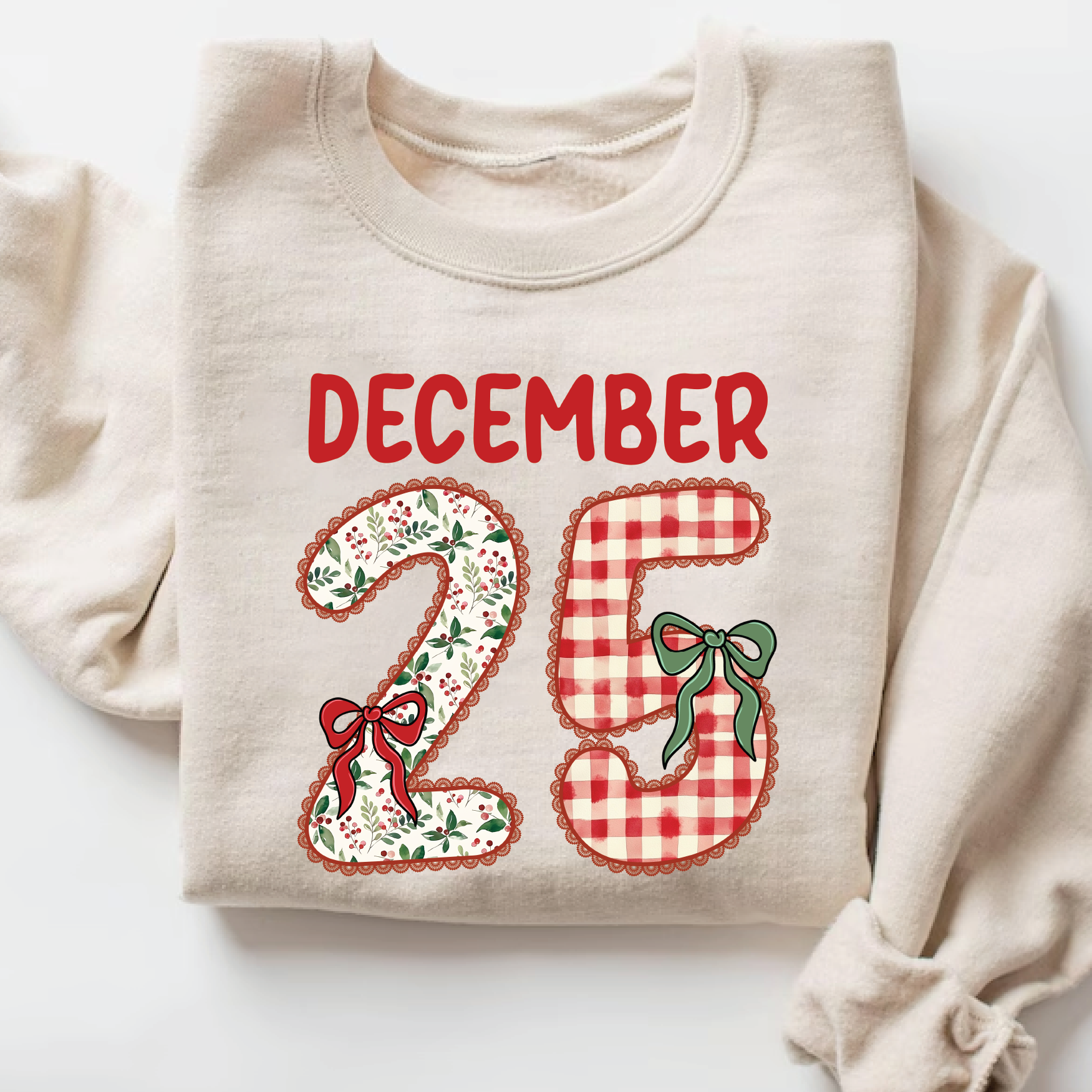 Beige Christmas sweatshirt with red “December 25” patchwork design and festive bows.