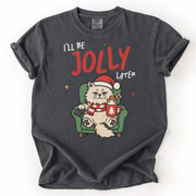 Black shirt featuring a grumpy cat in Santa hat sitting with cocoa and cookie, text “I’ll Be Jolly Later”