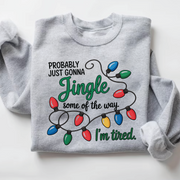 Funny Christmas sweatshirt with colorful Christmas lights and the quote “Probably Just Gonna Jingle Some of the Way, I’m Tired”