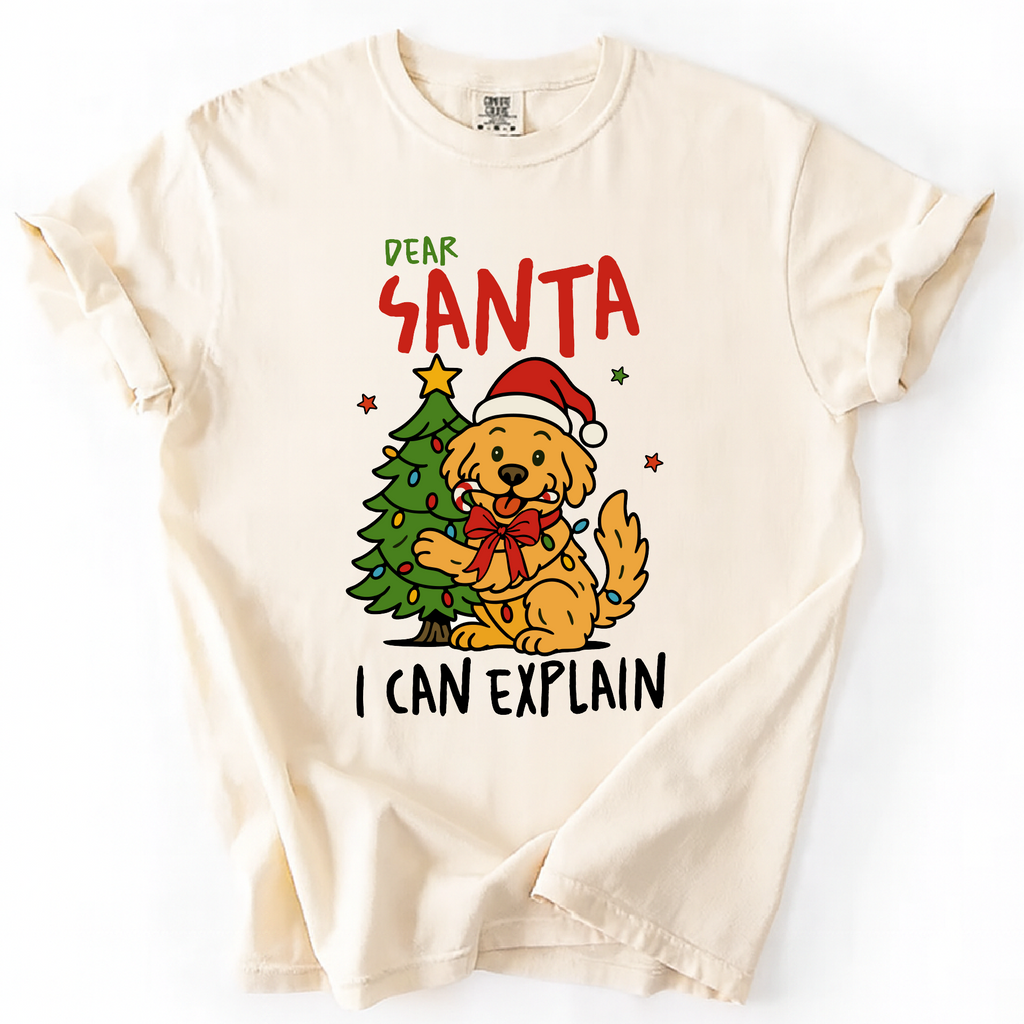 Ivory t-shirt with “Dear Santa I Can Explain” text and cute dog in Santa hat beside Christmas tree