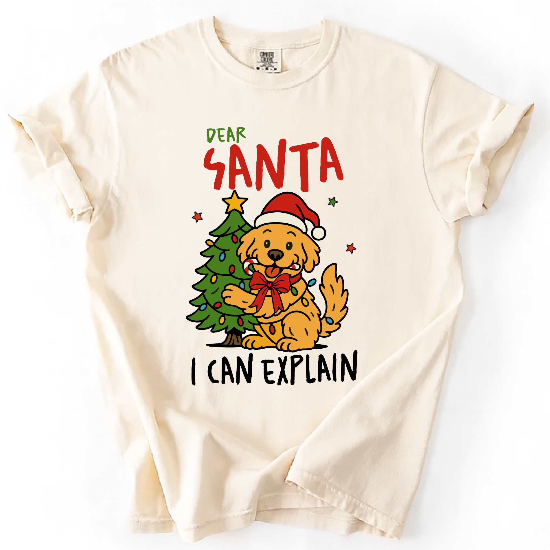 Ivory t-shirt with “Dear Santa I Can Explain” text and cute dog in Santa hat beside Christmas tree